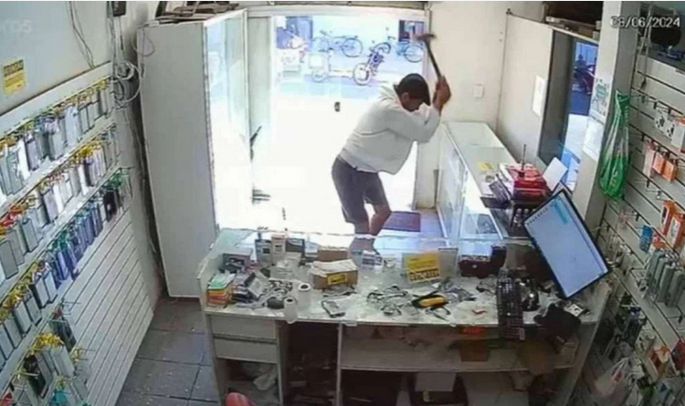 Imagens de câmeras de segurança registraram o momento em que um homem invadiu uma loja de celulares. Vídeo: