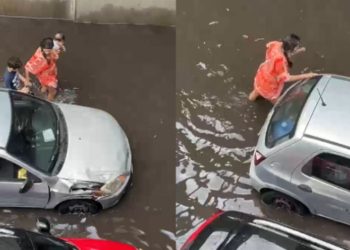 Após chuva, mãe com bebê no colo tenta empurrar carro na avenida Efigênio Sales