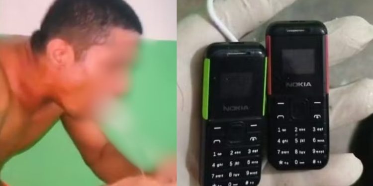 Detento tira da boca dois celulares e cabo USB